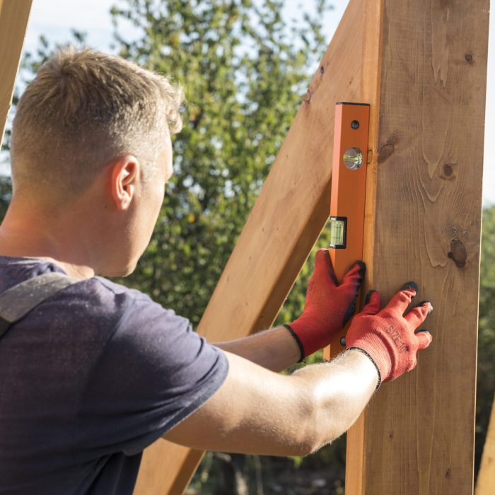 carpenter-man-taking-measures-wood-plank